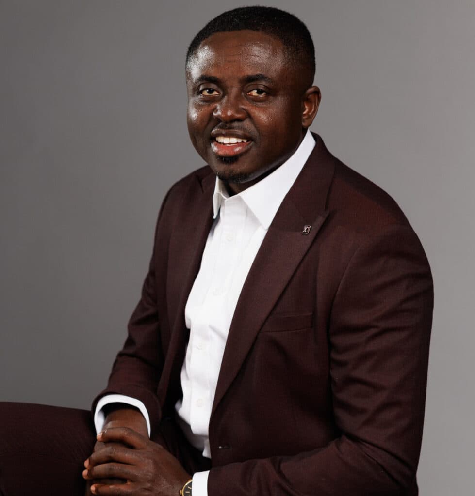 Reverend Prince Oppong Adjei seated, smiling